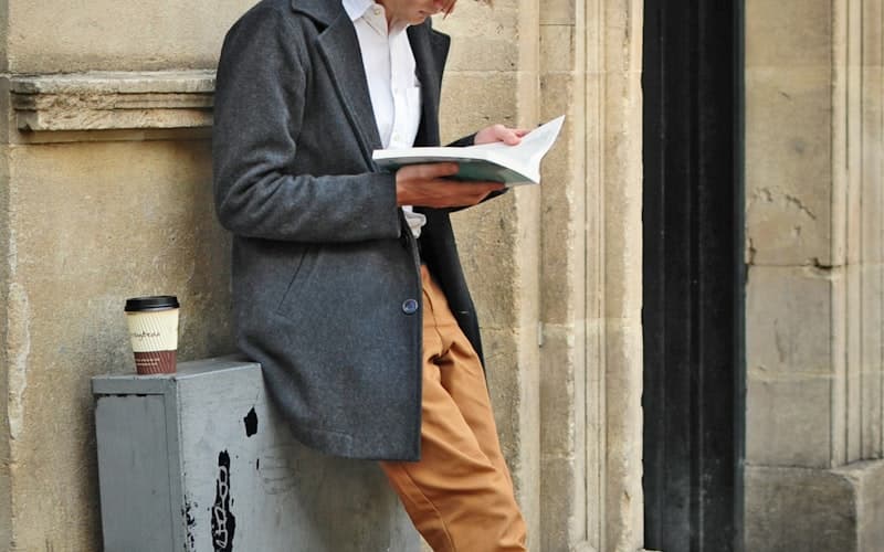 Person reading at high speed with books flying around
